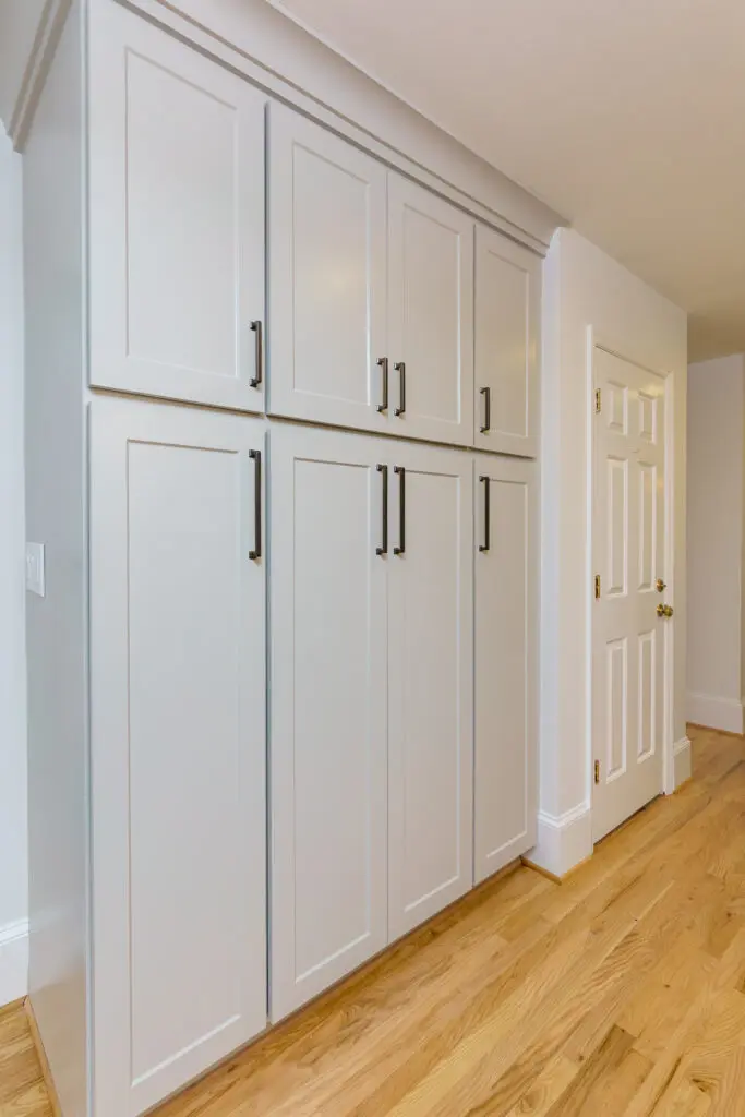 Tall pantry cabinets with smooth spray finish and clean lines