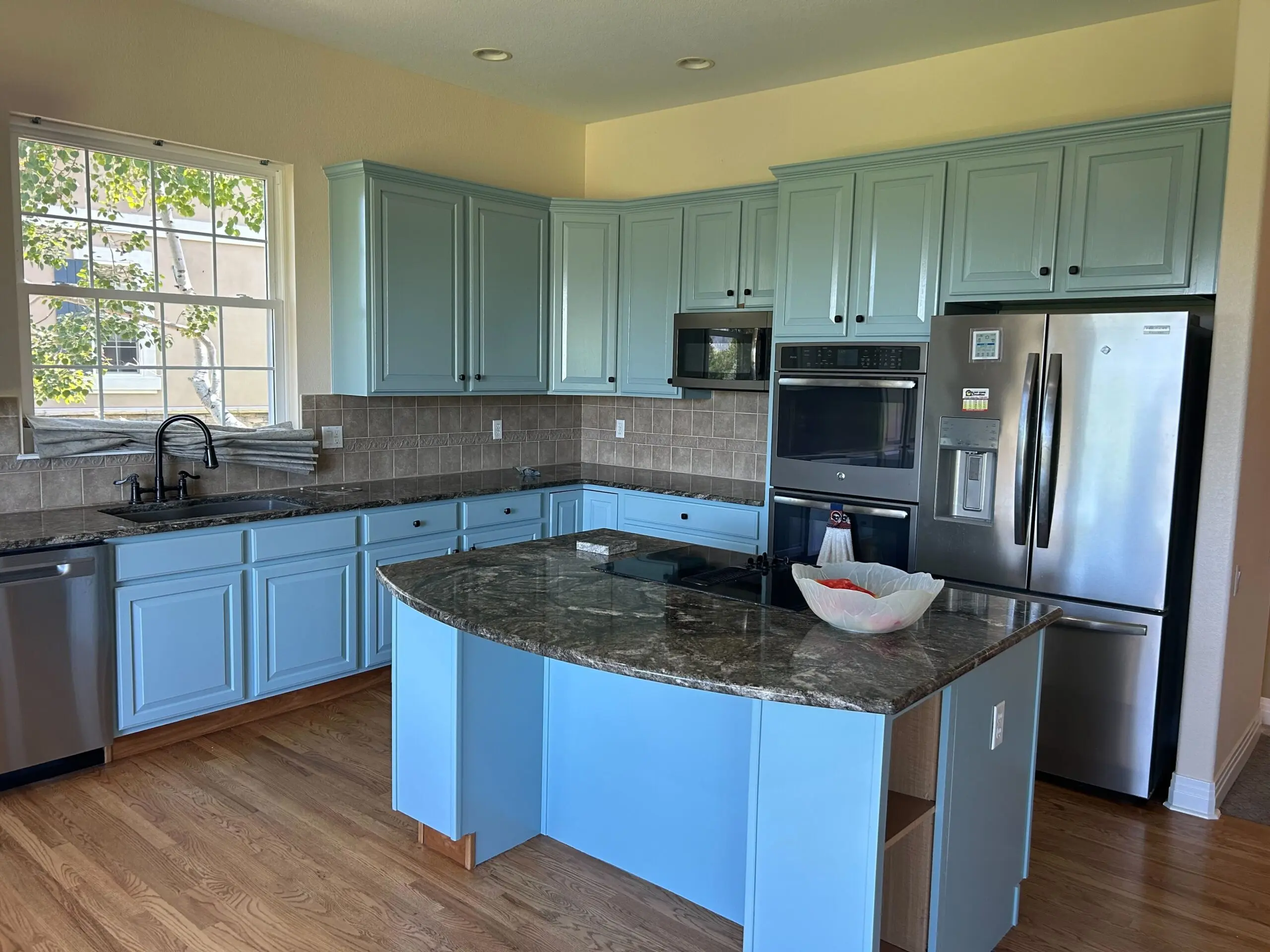 Light blue kitchen cabinets refinished with smooth cabinet-grade coating