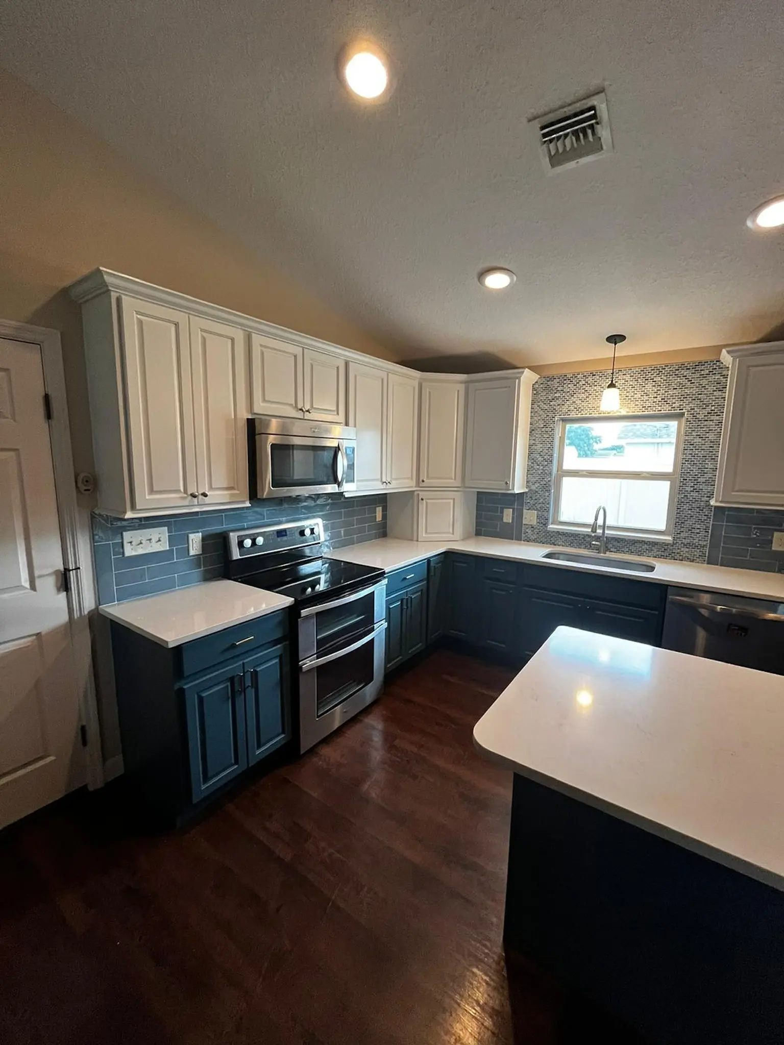 Two-tone kitchen cabinets with detailed trim and durable finish