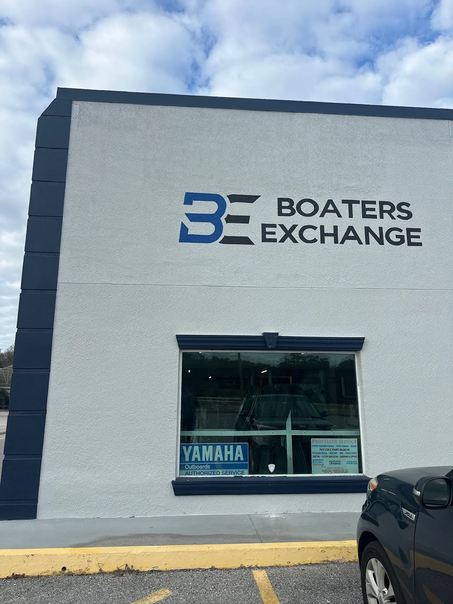 Commercial building exterior painting with new signage and clean finish