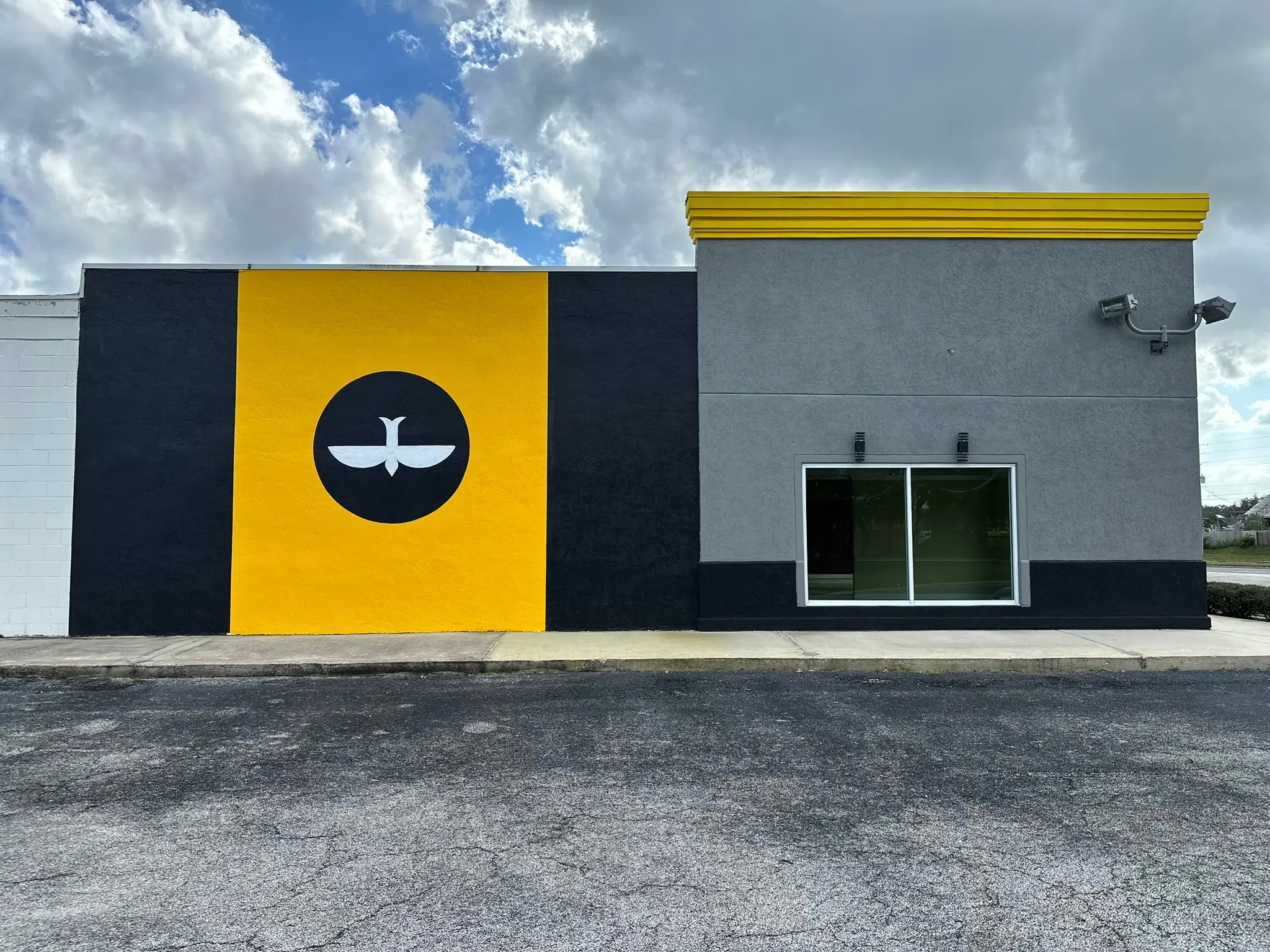 Commercial storefront exterior painting with bold color block design