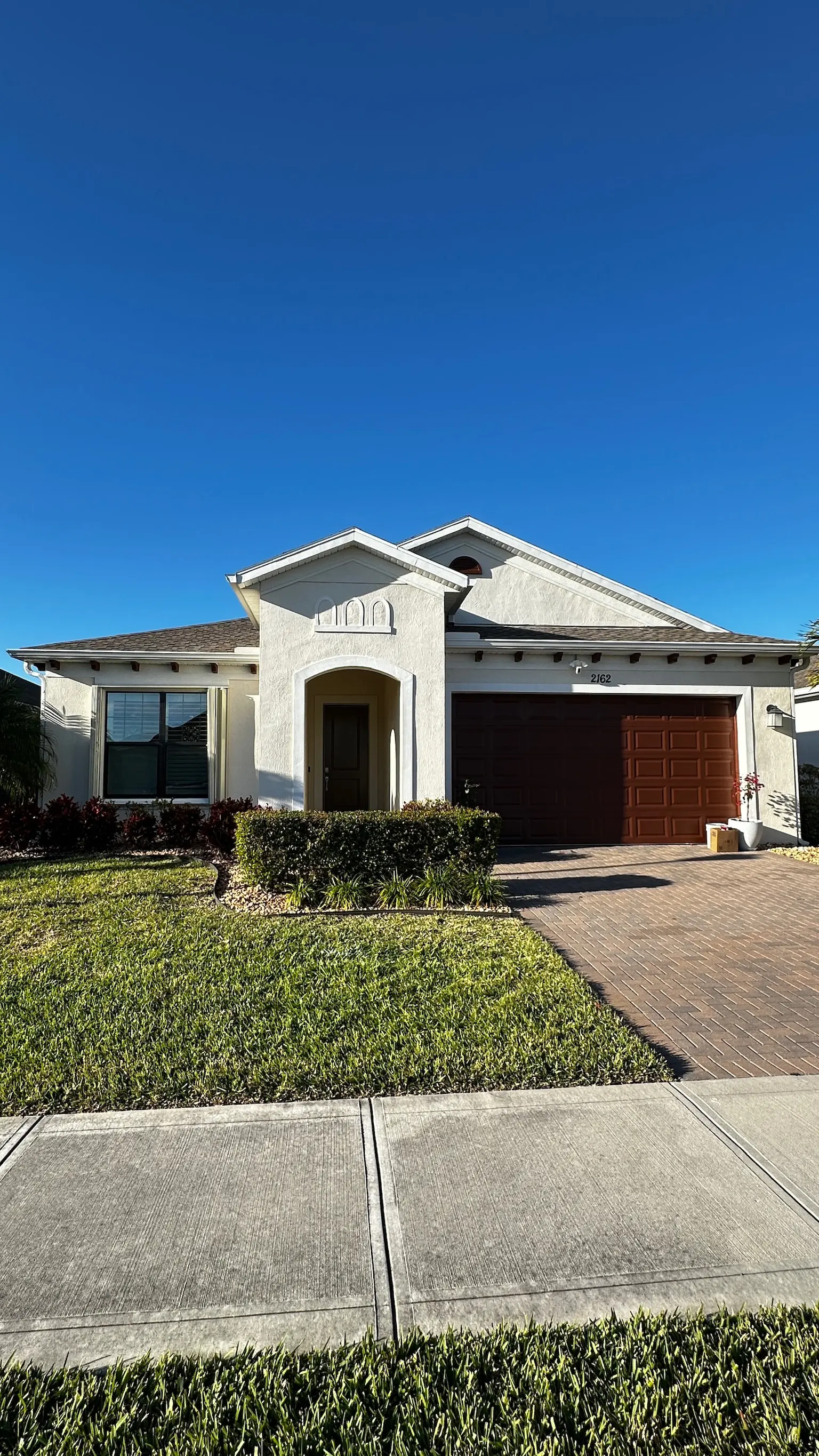 Home exterior after painting with refreshed stucco finish